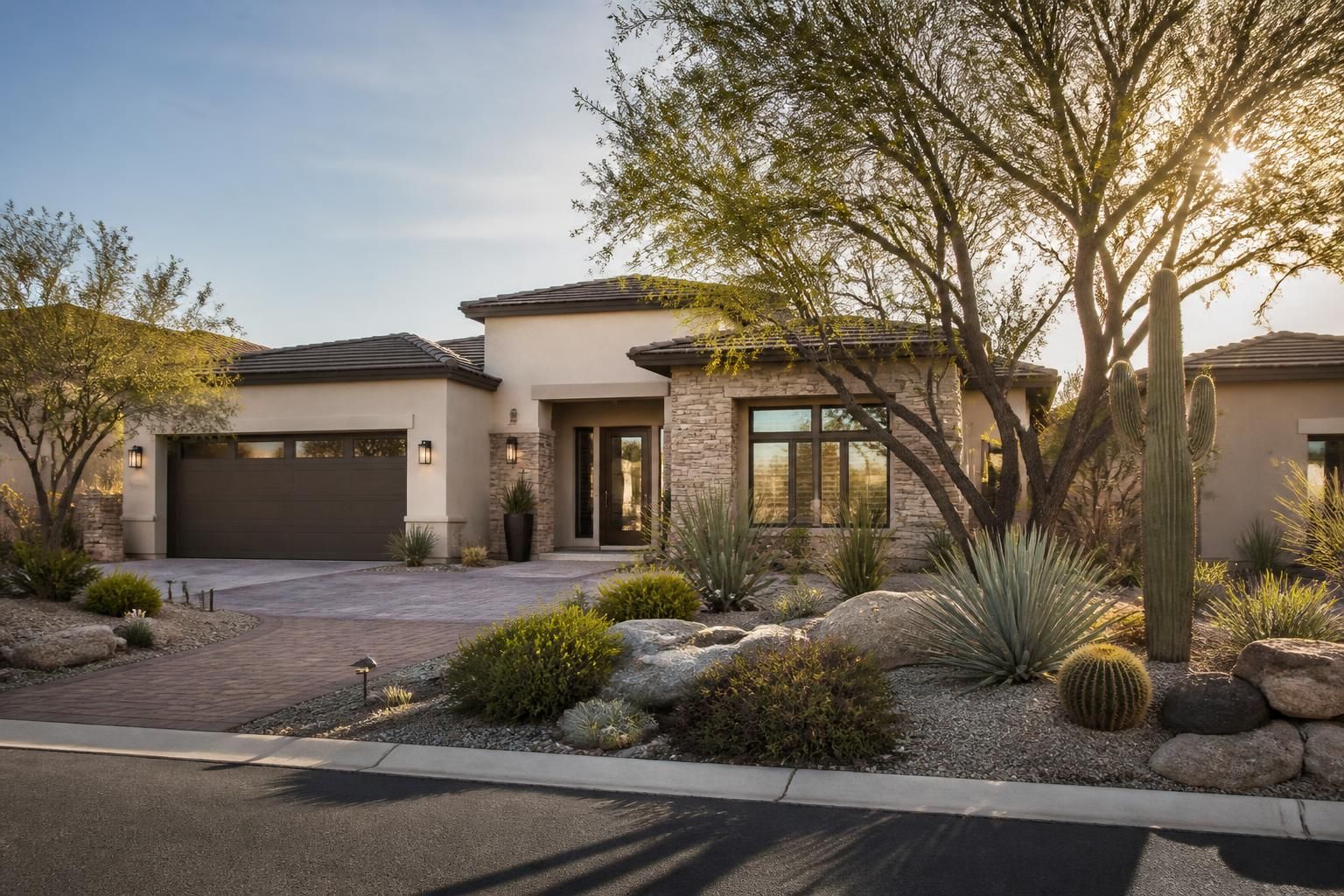 Upscale neighborhood with refined desert landscaping and warm sunlight.